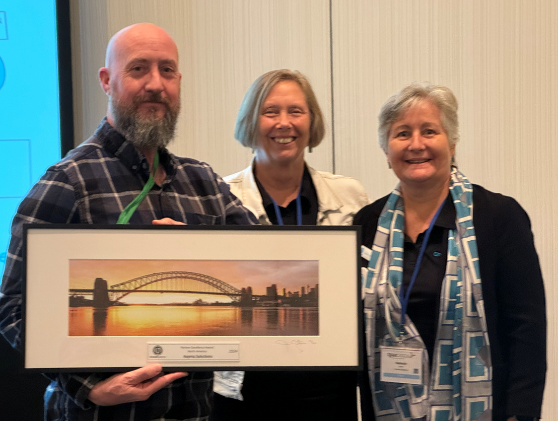 Rob Greeno from Asyma Solutions receives their award from Anne and Nathalie.