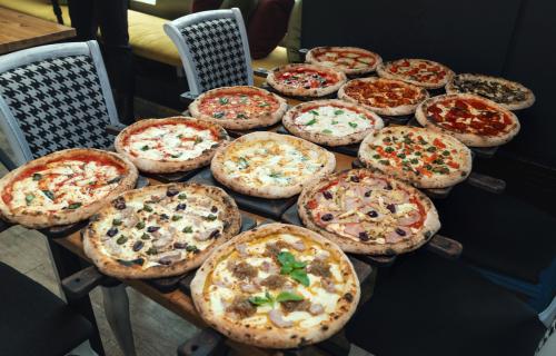Table full of pizzas