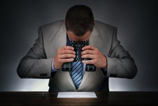 Man looking through binoculars